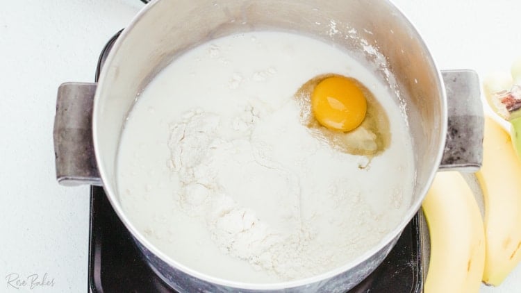 saucepan with sugar flour eggs and milk