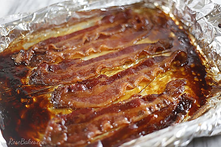 Cooked candied bacon on a foil lined baking sheet