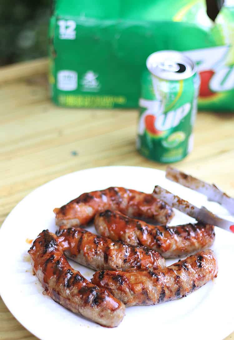 grilled brats with homemade 7UP BBQ sauce on table with 7up can