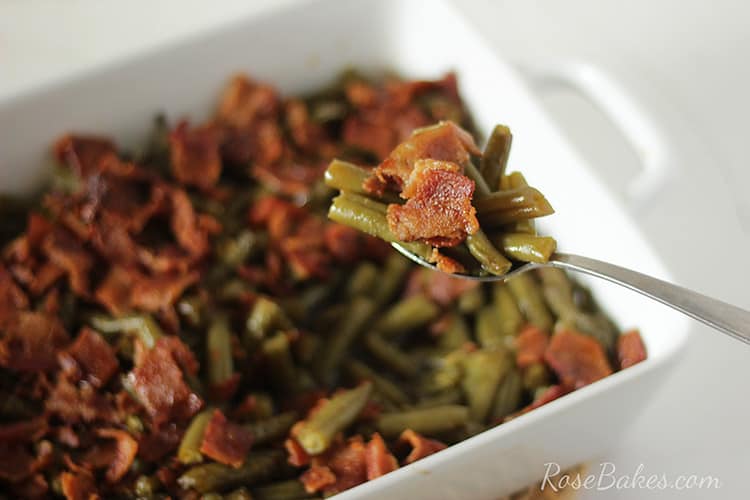 Bite of Green Beans on a spoon over the casserole dish