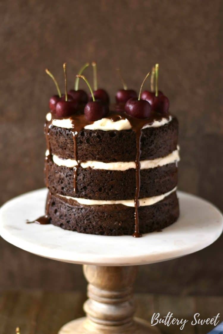 naked black forest cake with fresh cherries