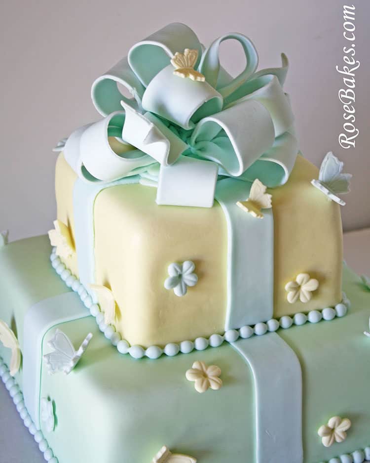 Pastel baby shower cake with gum paste bow, flowers and butterflies