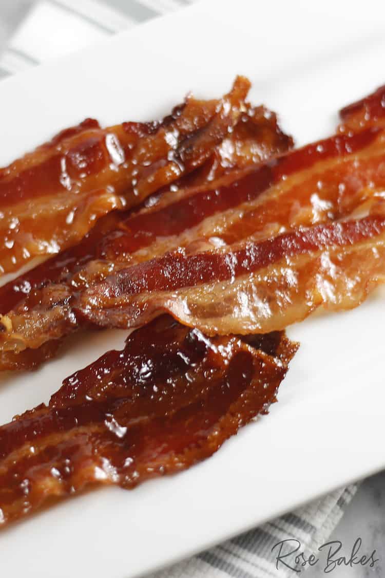 strips of maple candied bacon on a white platter.