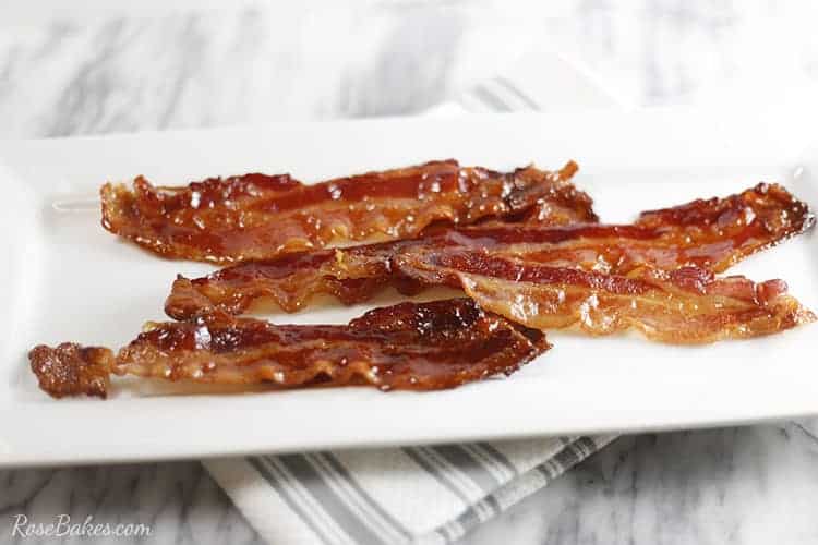 strips of Candied Bacon on a white platter.
