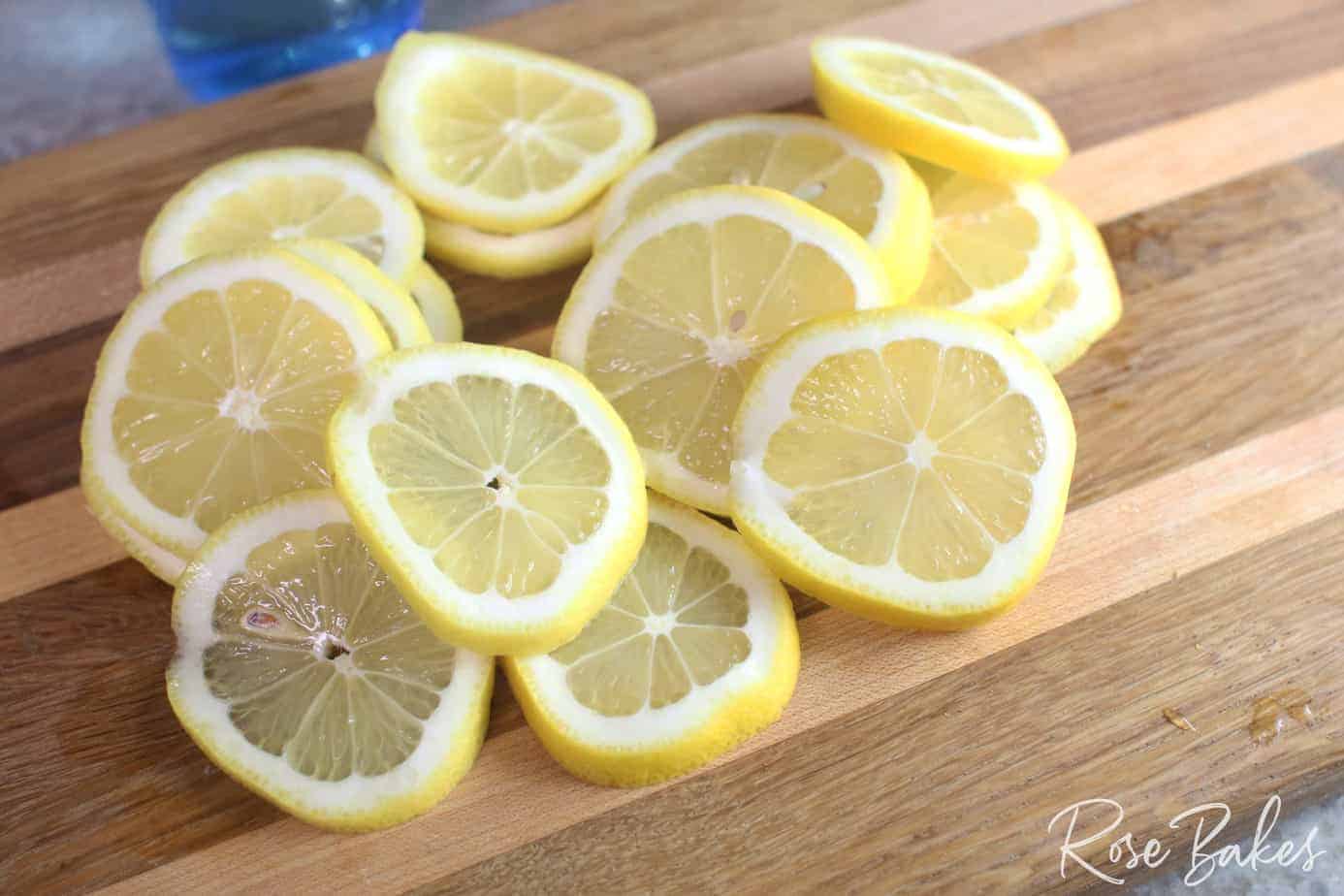 sliced lemons on a cutting board for candied lemons