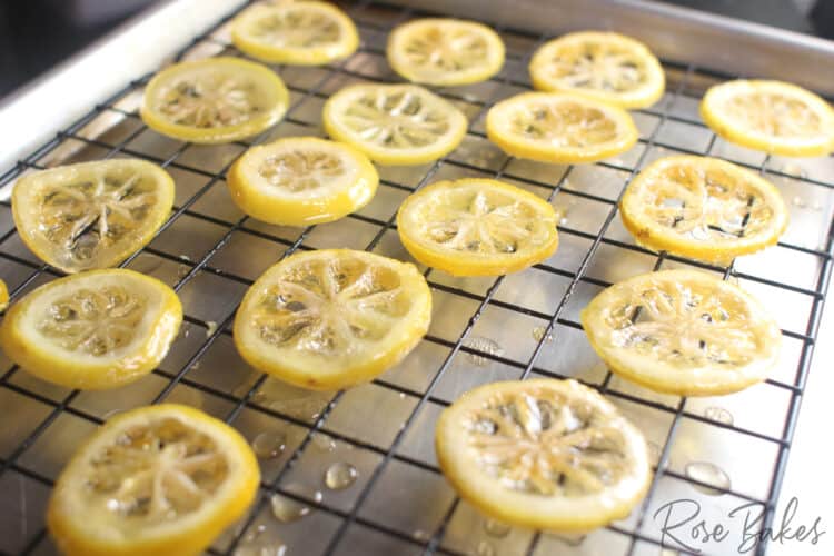 cooked candied lemon slices cooling on a cooling wack
