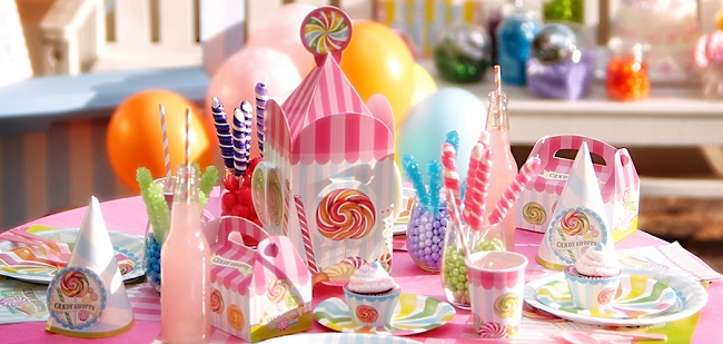 sweet shoppe candy party supplies on a pink table