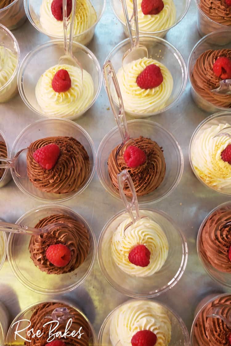 No-Bake Cheesecake Cups and No-Bake Chocolate Cheesecake Cups with raspberries on top and clear spoons