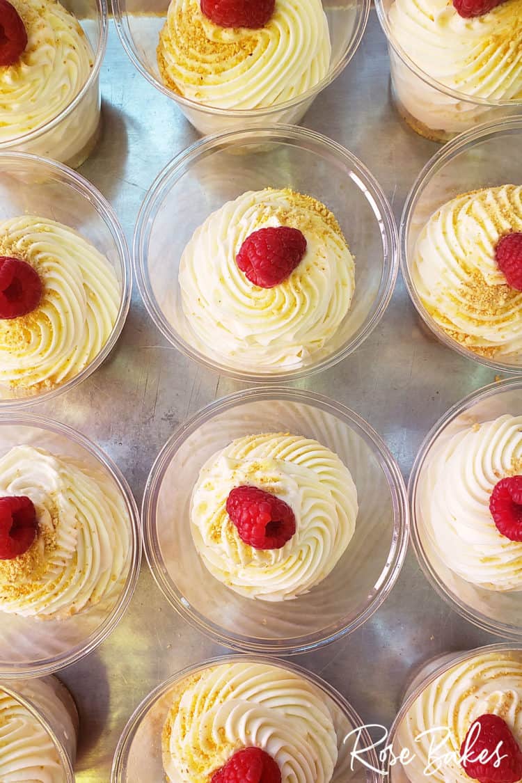 No-bake cheesecakes and no-bake chocolate cheesecakes on cookie sheets with raspberries