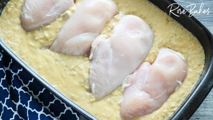chicken breasts laid in rice mixture
