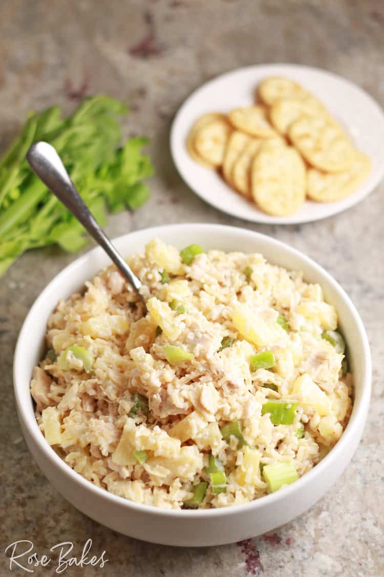 Bowl of Hawaiian Rice Salad with a plate of crackers in the background