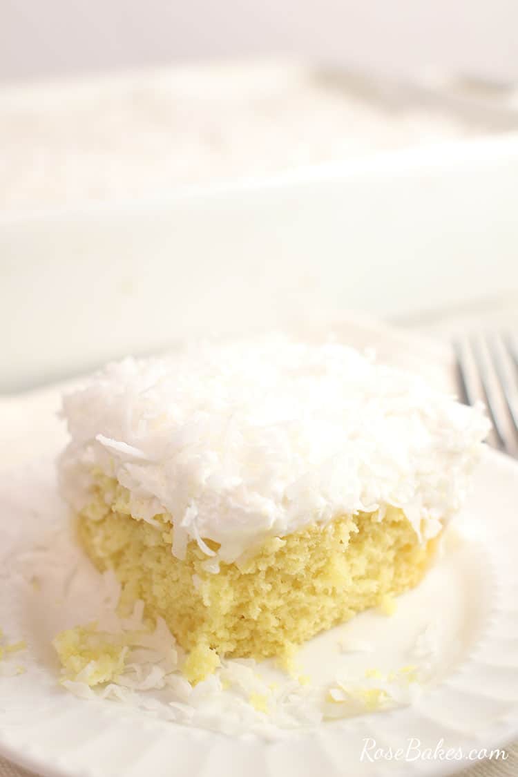 slice of coconut poke cake on a small white plate