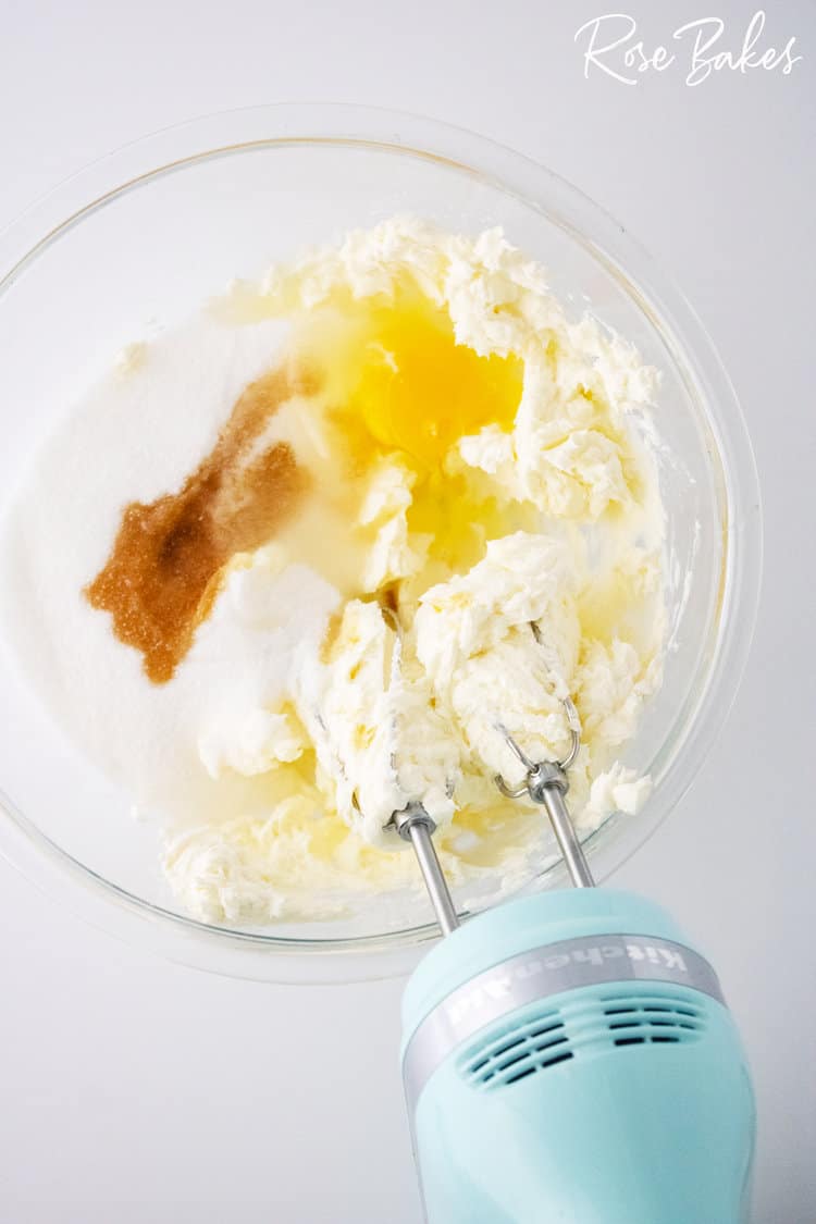 cream cheese danish filling ingredients in a clear bowl with blue mixer