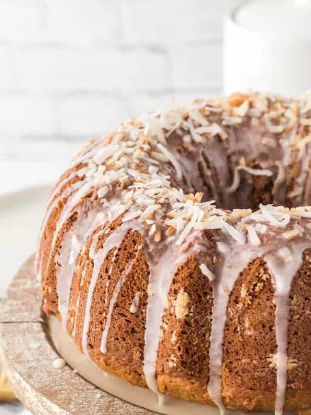 Coconut Bundt cake close up showing the glaze and toasted coconut sprinkled on top.