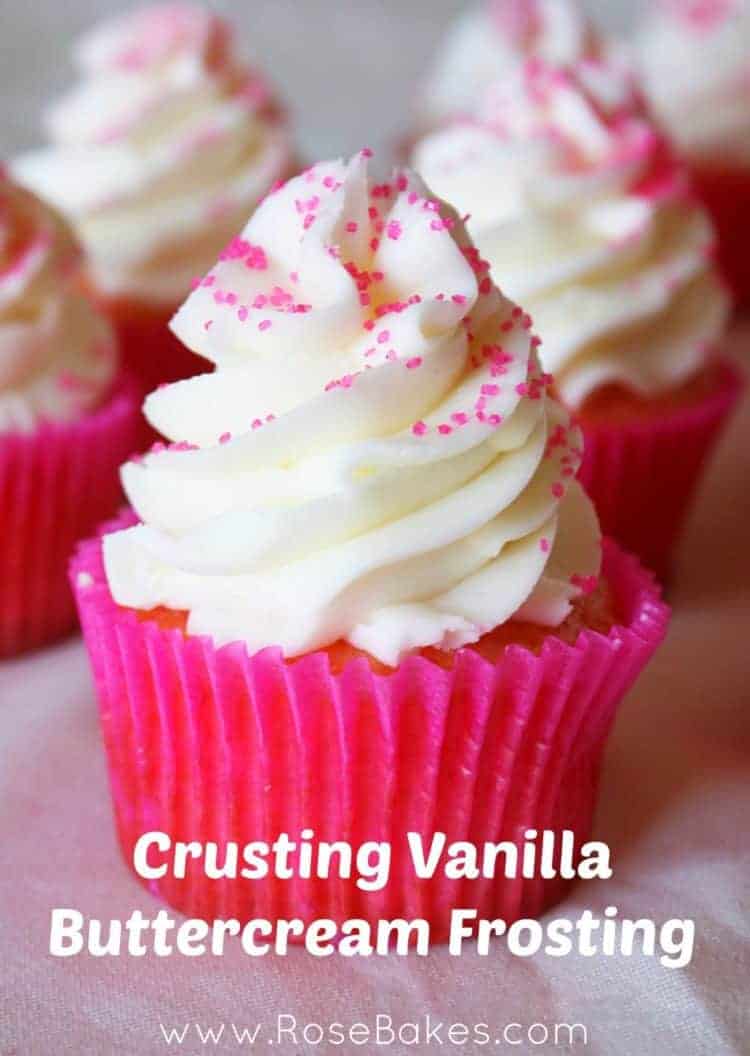 Vanilla buttercream on a pink cupcake with sprinkles