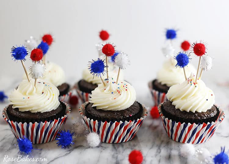 Easy 4th of July Cupcakes with firecracker cupcake toppers on toothpicks in red white and blue lines cupcake toppers