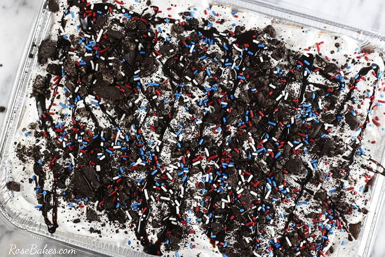 Top view of the pan of ice cream sandwich cake with Oreo crumbs and red white and blue sprinkles