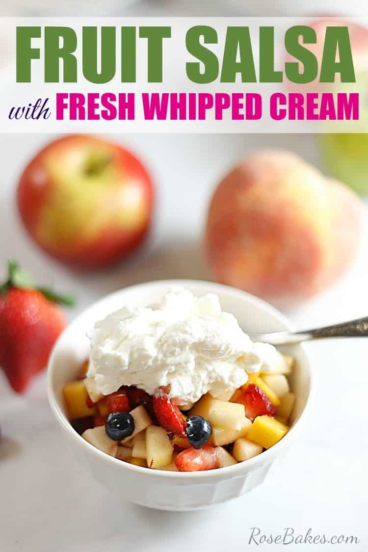 Bowl of fruit salsa topped with fresh whipped cream