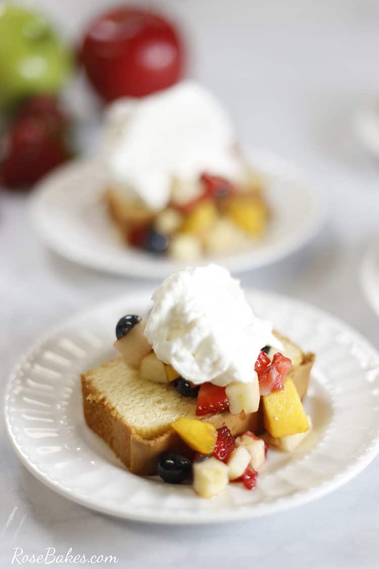 Dessert plate with a slice of pound cake topped with fruit salsa and whipped cream.