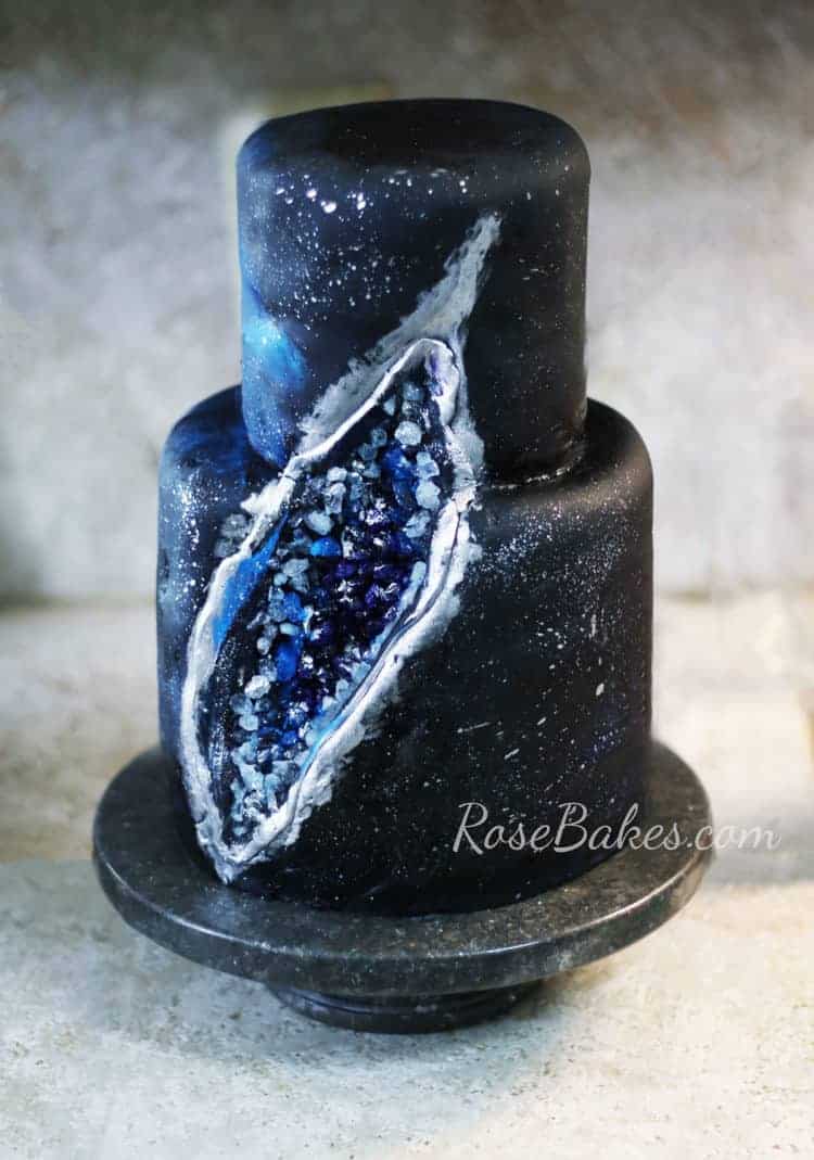black purple and blue galaxy geode cake with candy filled inside