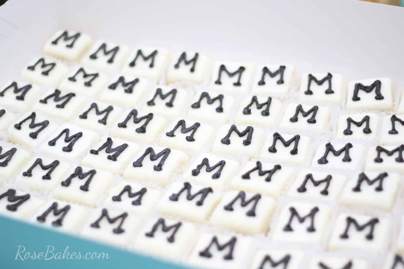 petit fours boxed up with the letter M on each.