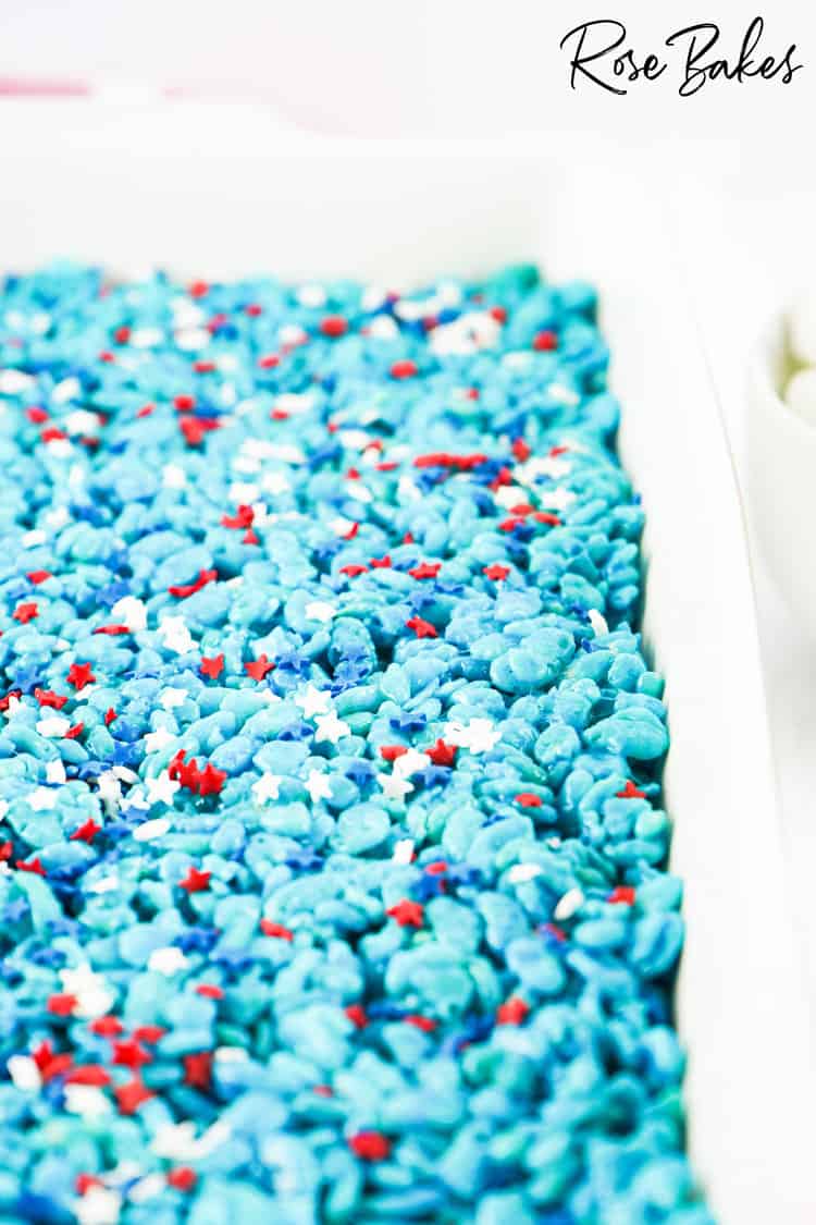 Blue Rice Krispie Treats with patriotic sprinkles on top in a baking dish