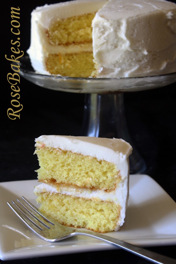 lemon icebox cake frosted and set on clear cake stand