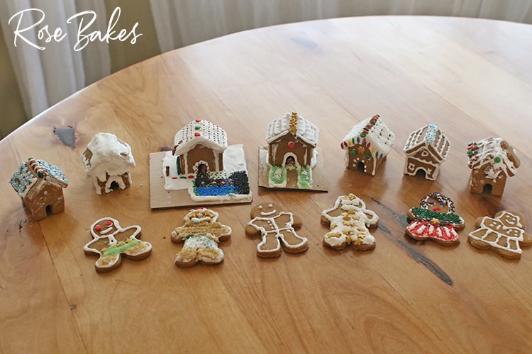 Seven mini gingerbread houses and 6 gingerbread men and women for How to Make Mini Gingerbread Houses with Kids post