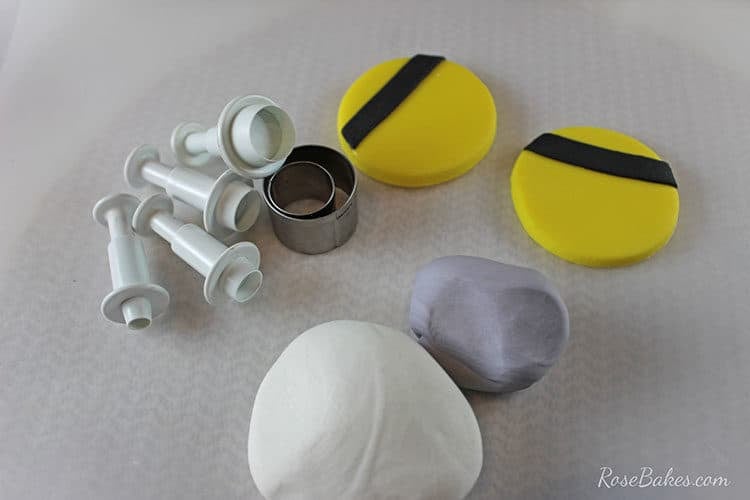 white and gray fondant in small balls with mini round cutters and circle plungers cutters
