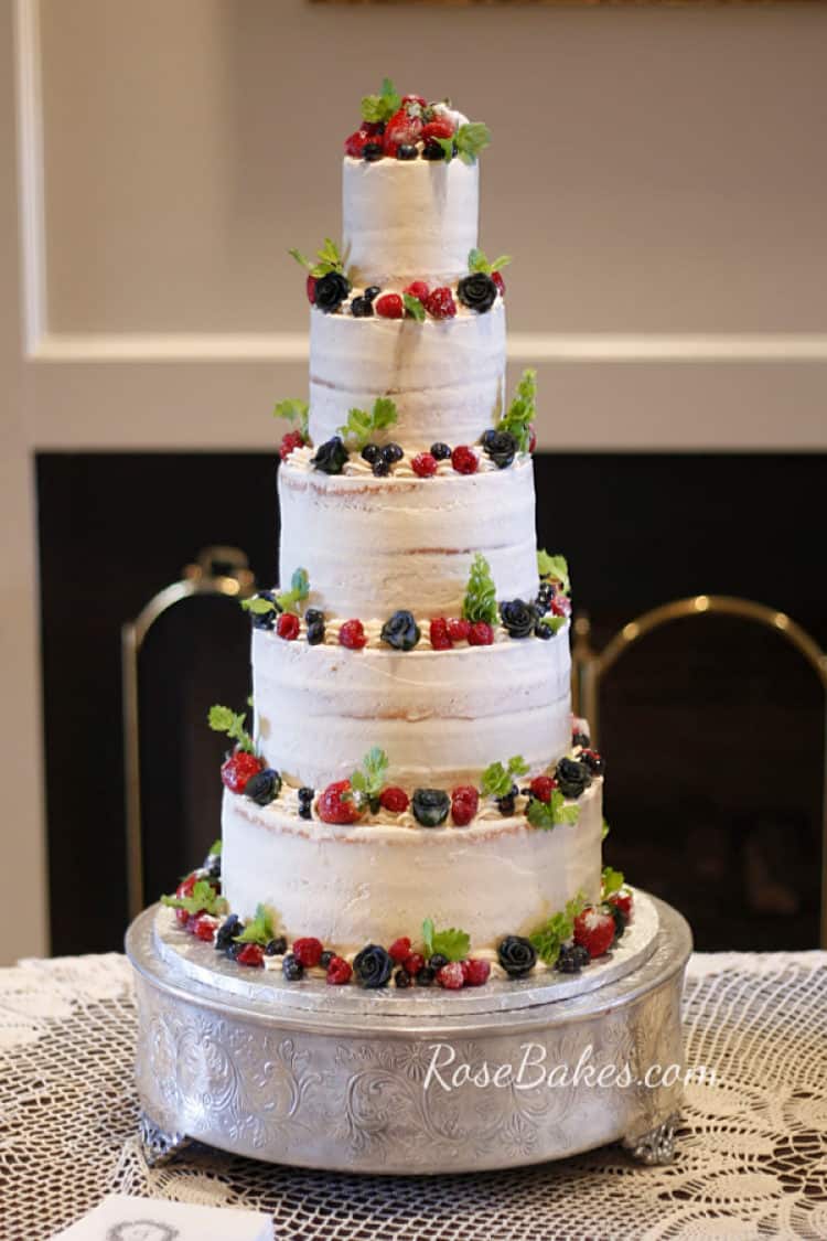 nearly naked wedding cake with fresh fruit