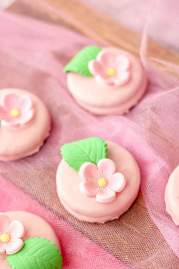 easy flower oreos - pink with pink flowers and leaves on pink lace
