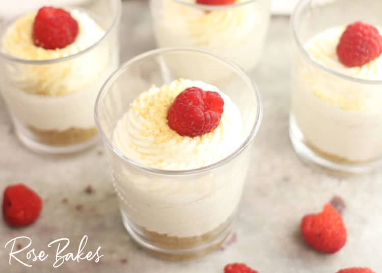 Creamy No-Bake Cheesecake Cups Recipe in cups with raspberries on top 