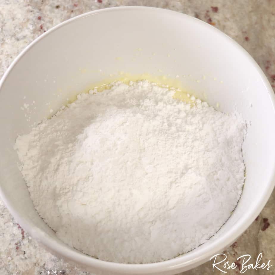 powdered sugar being added to smoothly mixed ingredients 