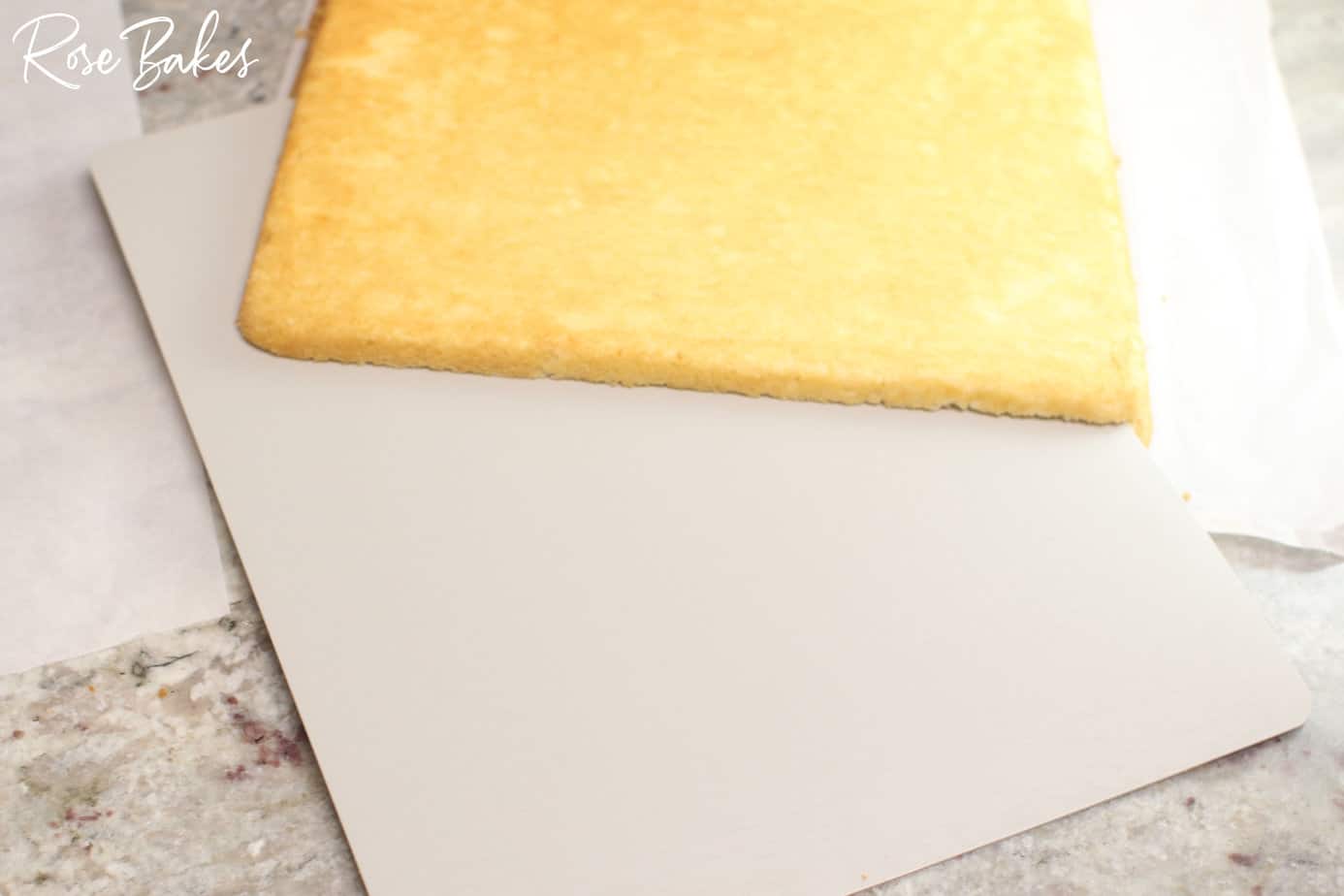 separating the cake layers with a thin board to lift the top layer off.