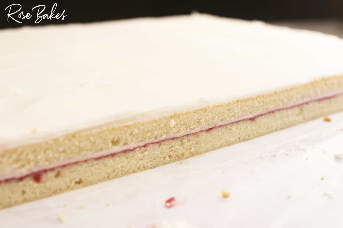 Smooth cut edge of cake showing the filling in the middle.