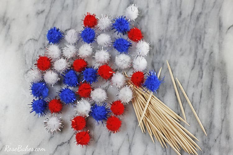 red white and blue pompoms plus a scattering of toothpicks
