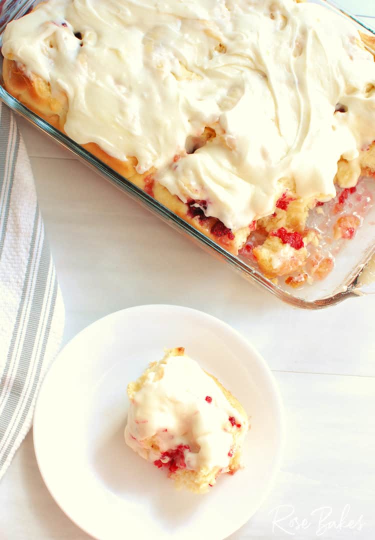 Raspberry Cinnamon Rolls Recipe - pan of baked sweet rolls plus one on a white white plate