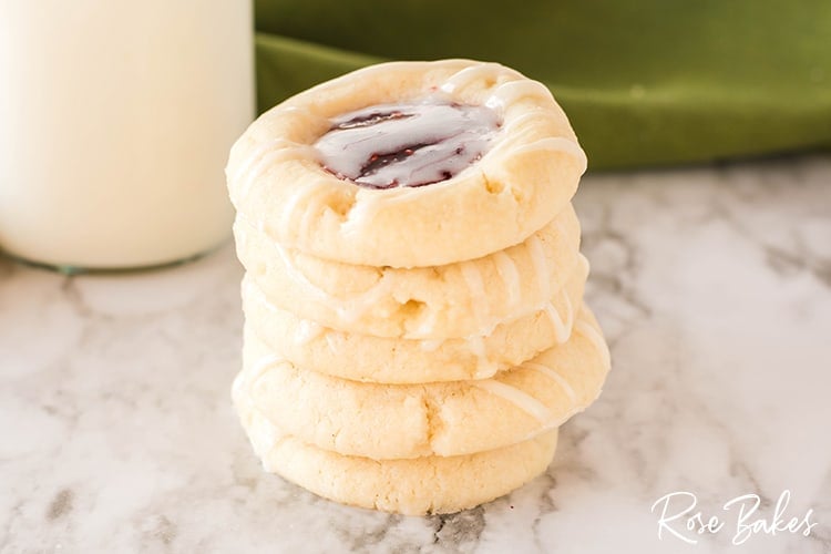 A stack o fRaspberry Thumbprint cookies with a vanilla almond glaze 