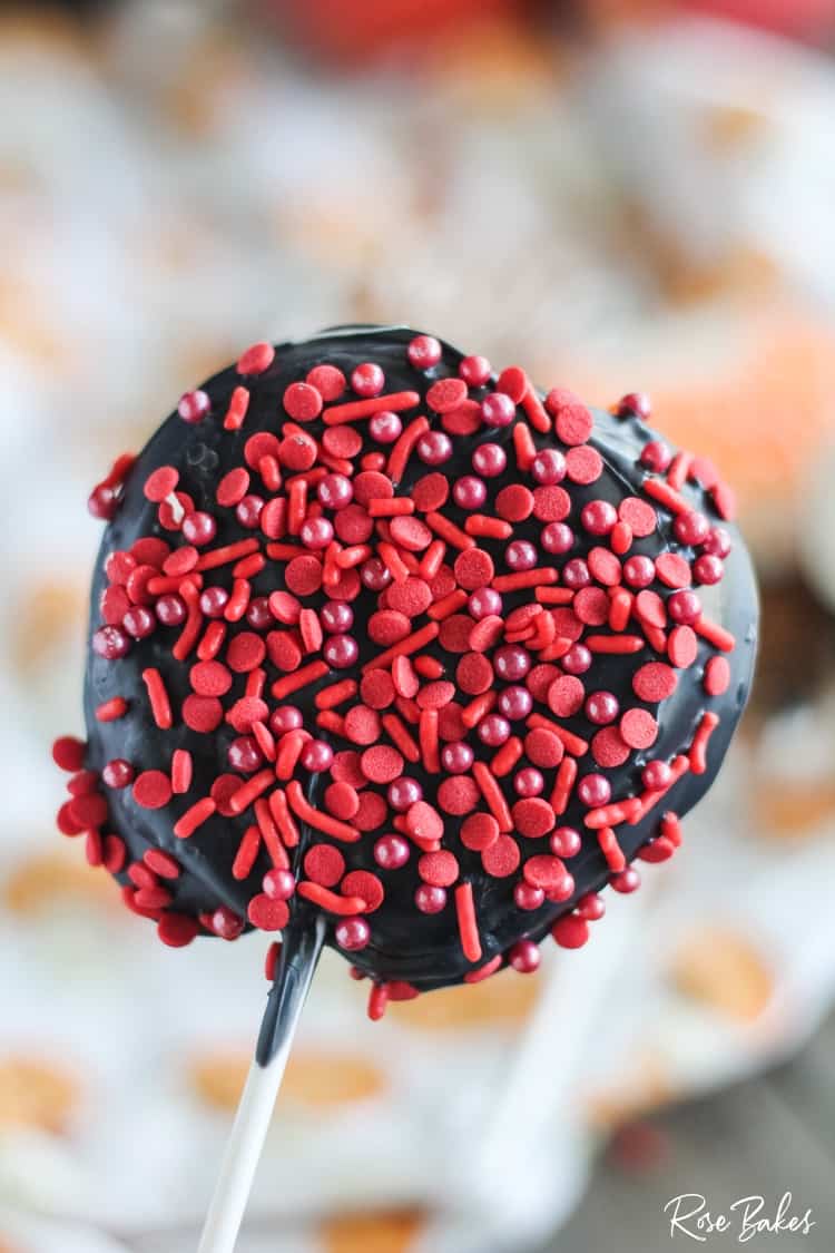 apple slice dipped in chocolate and red sprinkles