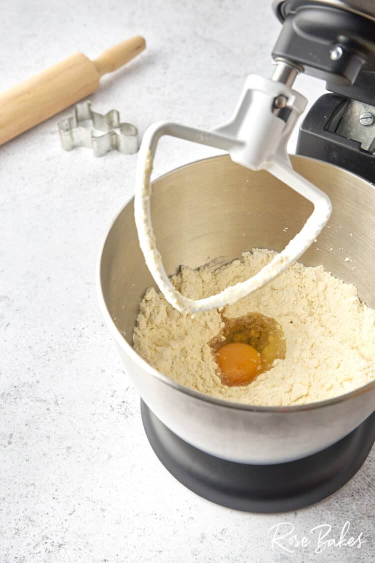 Stand mixer with egg and vanilla extract added to the other ingredients.