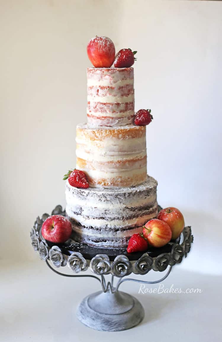 nearly naked wedding cake with fresh fruit