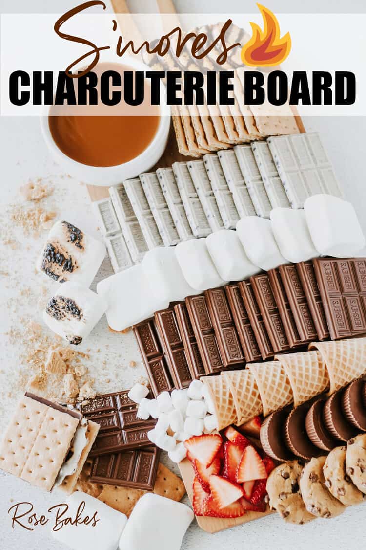 S'mores Charcuterie Board - a Campfire S'mores Board or S'mores Dessert Board filled with  marshmallows, chocolate bars, graham crackers, cookies strawberries and caramel sauce