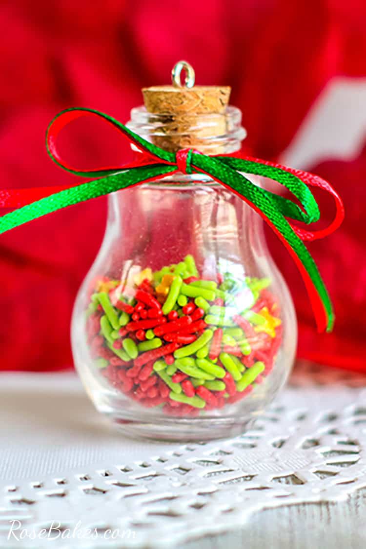 DIY Christmas Ornament with Sprinkles on a white doily with red background