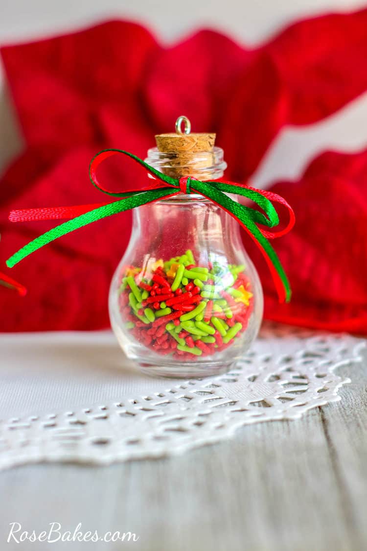 Glass Bulb Sprinkles Christmas ornament on a white table wtih ribbons