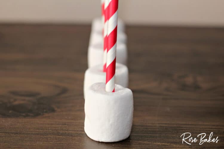 marshmallows on red and white straws
