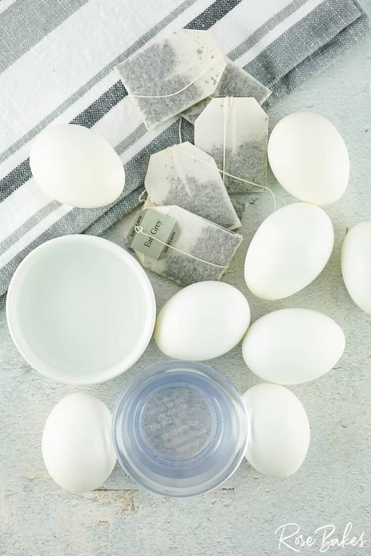 white eggs and black tea bags on counter prep for dyeing 