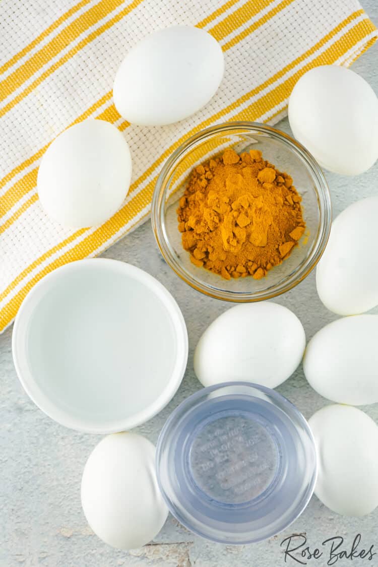 Turmeric in bowl and white eggs set up around for dye