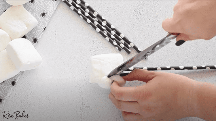white marshmallows being cut with knife