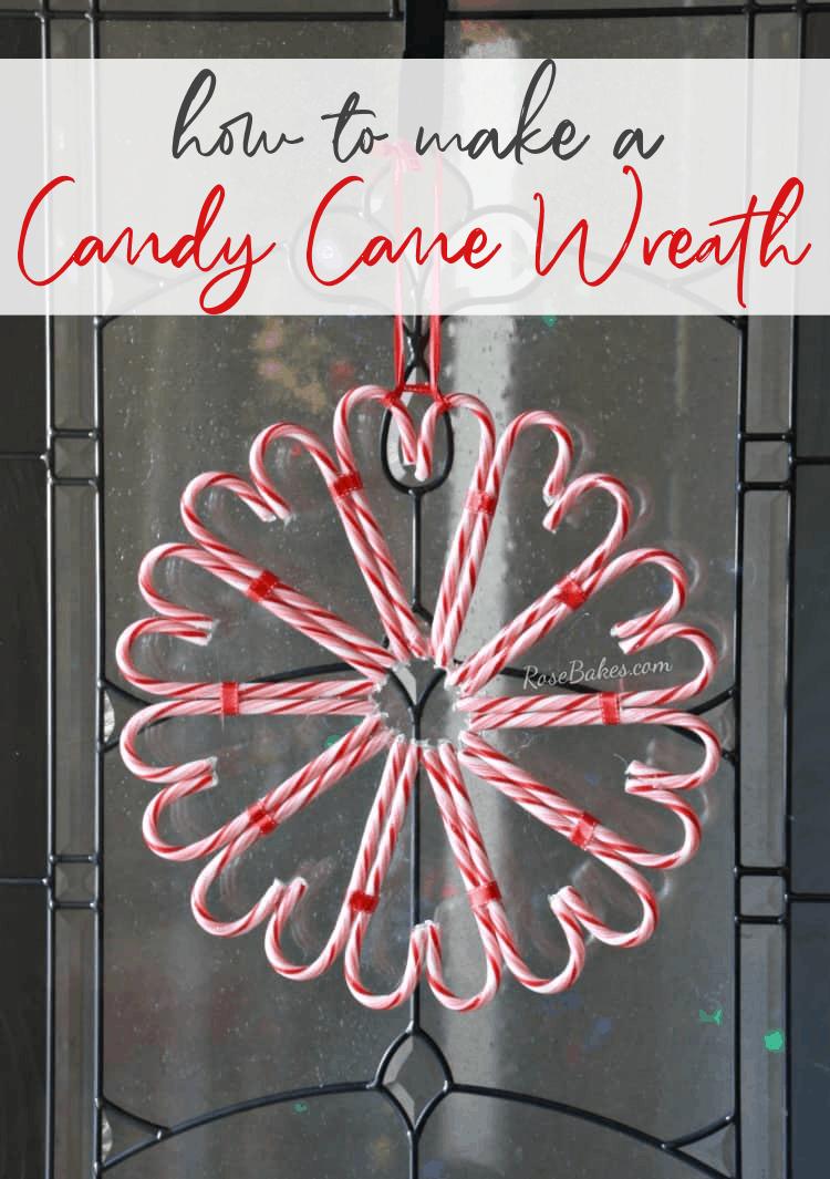 Completed candy cane wreath hanging on a door with the text "how to make a candy cane wreath"